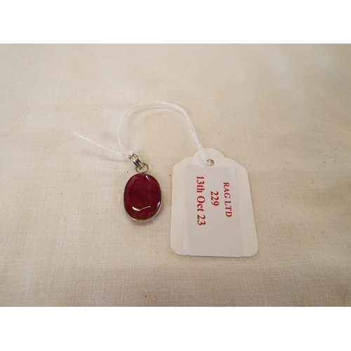 229 - A silver pendant inset with ruby