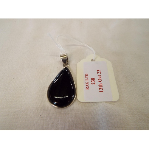 238 - A silver pendant inset with black onyx stone