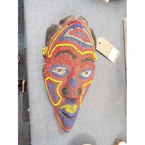 270 - A late 19th early 20thC facemask from the Cameroon having vibrant colour and varied shape