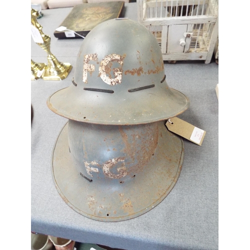 272 - Two WWII British Army helmets marked FG