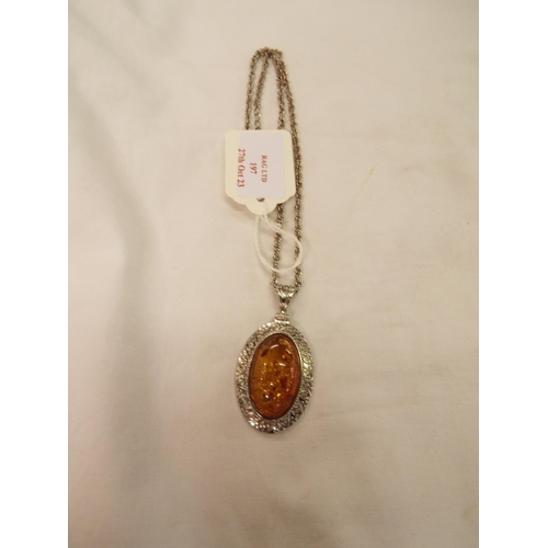 197 - A white metal pendant inset with amber and a white metal chain