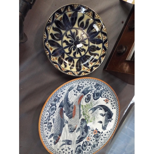 480 - A large decorative plate having koi carp decoration and a bowl having floral decoration