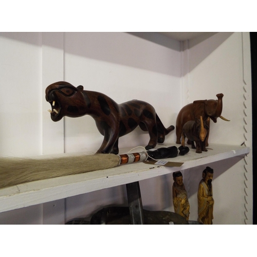 394 - A carved African figural fly swat, Leopard, Rhino and Elephant
