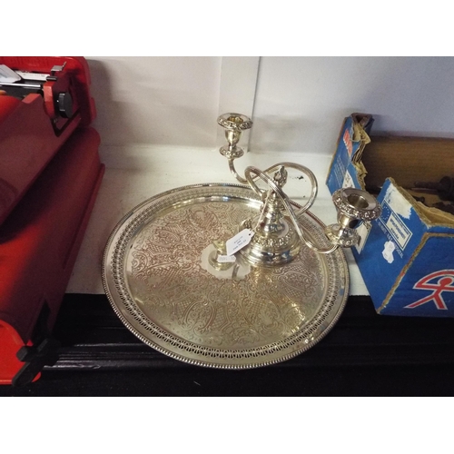 400 - A silver-plated candelabra and a silver-plated round tray