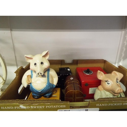 406 - A mixed selection of money boxes to include NatWest Pig, Cadburys Chocolate, etc