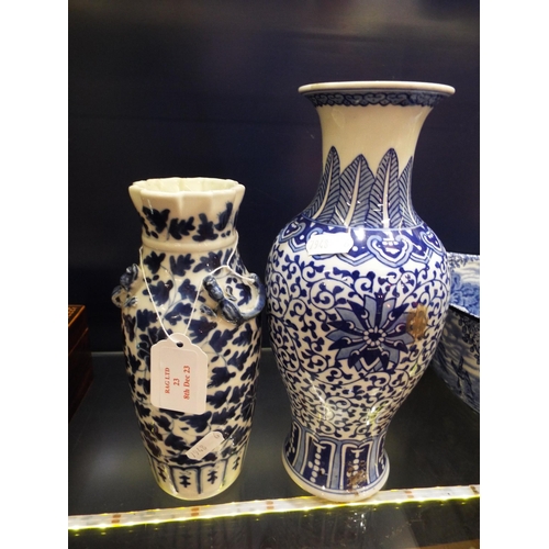 23 - Two Oriental blue and white vases with floral decoration