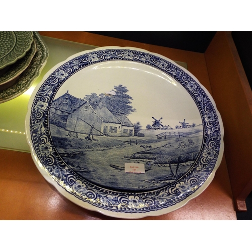 127 - A large blue and white Delfts charger depicting a windmill scene signed J Sonneville