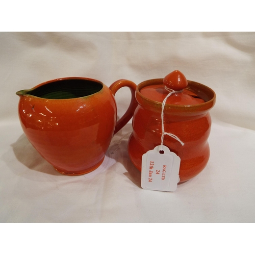 24 - A Rye Pottery Uranium orange and green glazed cream jug 3.5
