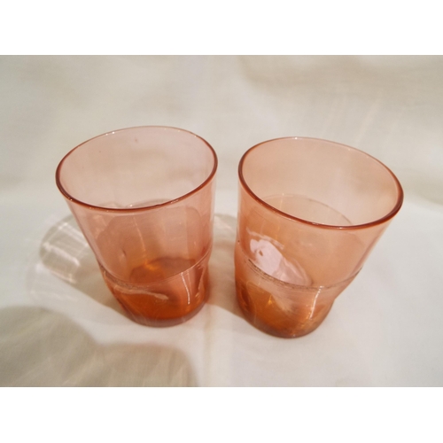 31 - A pair of Victorian Whitefriars Harry Powell cranberry glass tumblers with thumb print and ribbed de... 