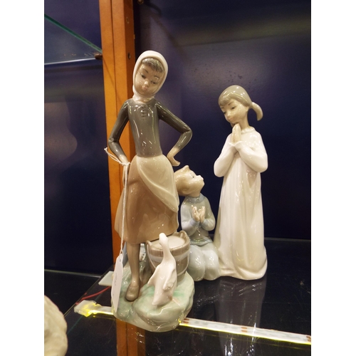44 - Two Lladro figurines girl with duck and children praying