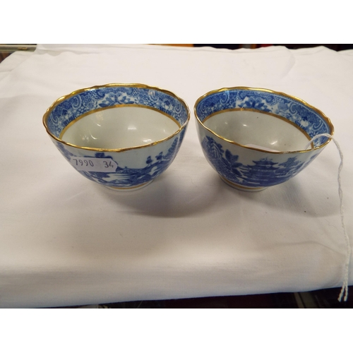 169 - A pair of Oriental style tea bowls with willow pattern decoration