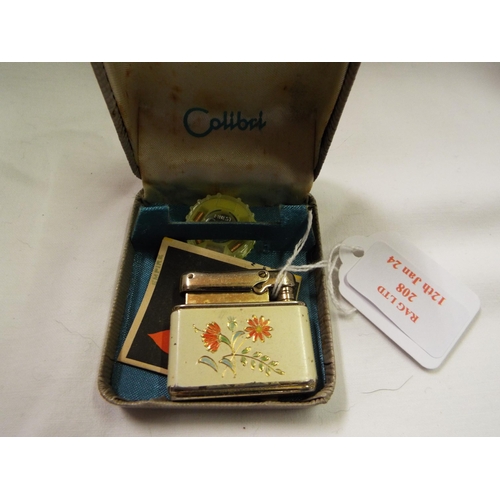 208 - A vintage enamel Calibri Monopol enamel lighter having floral decoration