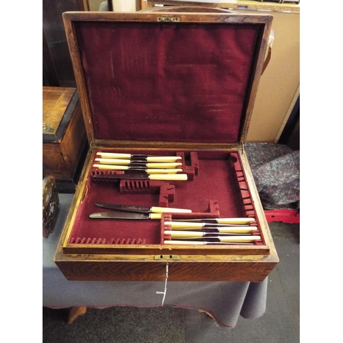 355 - A good quality oak and velvet lined canteen with a selection of bone handle knives (with key)