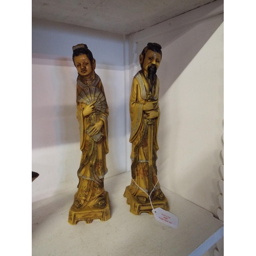 448 - A pair of Oriental resin figures