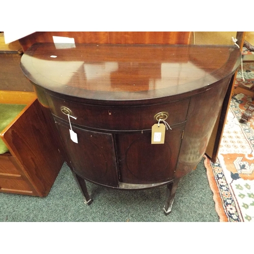 608 - A mahogany bow-fronted drinks cabinet resting on tapering supports