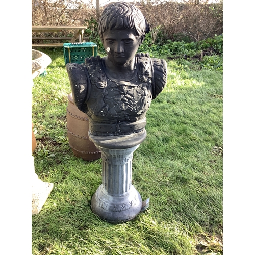 304 - A black painted concrete Roman bust of a soldier on pedestal base