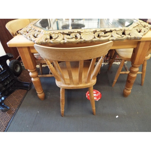 566 - A pine kitchen table and four rail back chairs