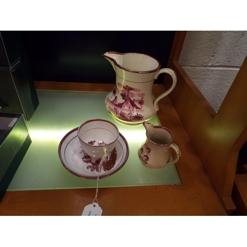 112 - A Sunderland lustre water jug, cream jug, a cup and two saucers