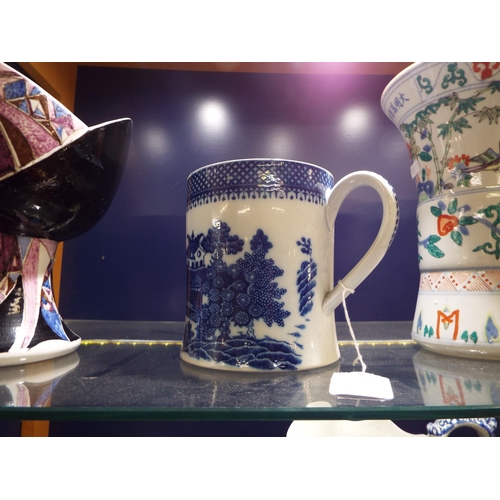 17 - A Chinese Canton late 18thC early 19thC blue and white tankard with pagoda decoration (hairline crac... 