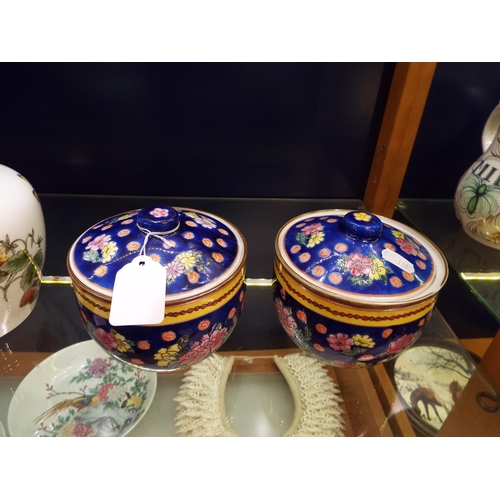 25 - A pair of Chinese lidded pots with floral decoration red seal marks to base (small rim chip to one)