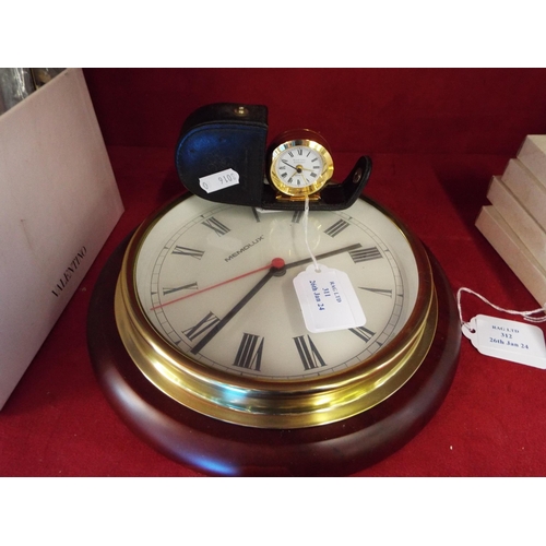 311 - A circular wall clock and small alarm clock