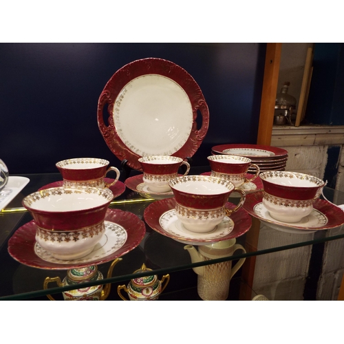 33 - An Austria tea set comprising of six cups and saucers, cake plate and sandwich plate