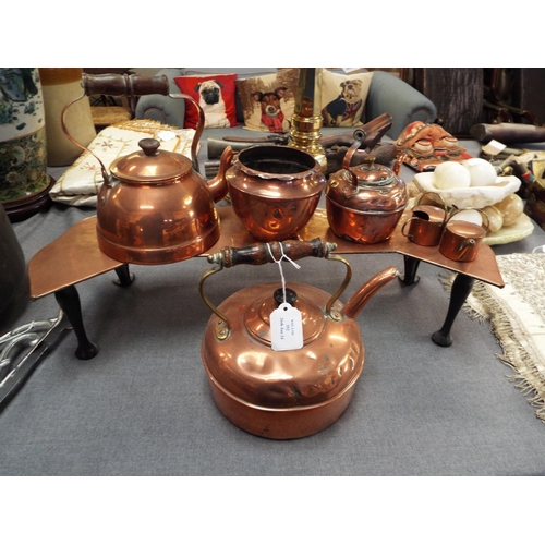 352 - A copper trivet together with three copper kettles, a bowl and two miniature watering cans