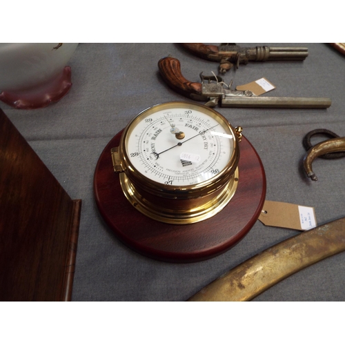 362 - A brass Aneroid barometer on wooden plaque