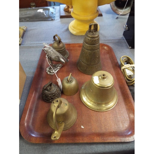 367 - A selection of brass bells to include cow bell and a white metal eagle on tree