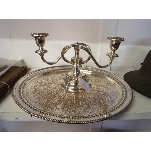 410 - A silver-plated candelabra and a silver-plated round tray