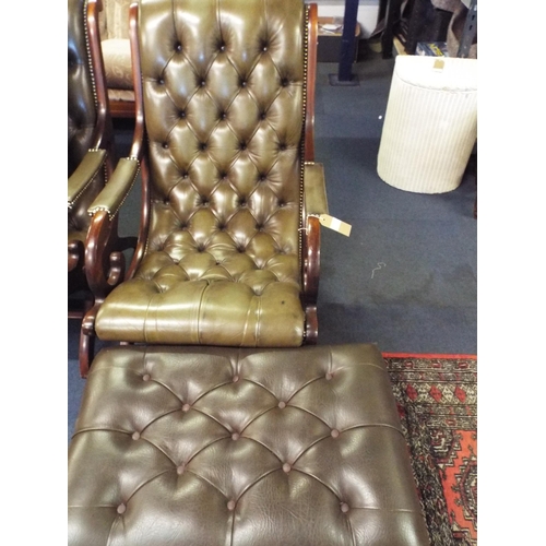 475 - A green leather button back and studwork chair with scroll arms and similar footstool