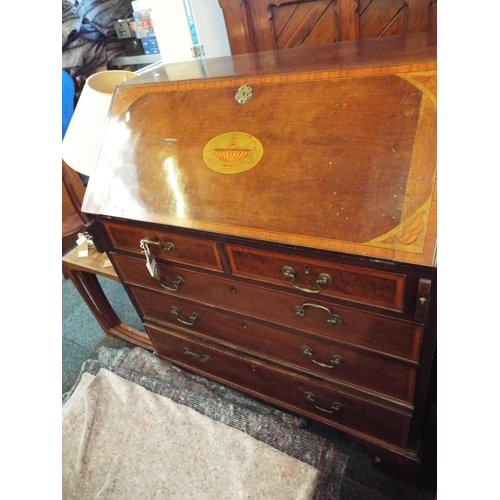 525 - A George III mahogany cross-banded bureau the full flap with classical urn inlay, enclosing inner co... 