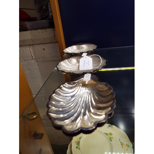 63 - Four Walker & Hall silver-plated scallop shaped dishes