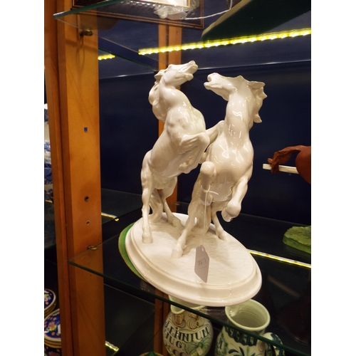 7 - An Austrian white glazed figure of two wild rearing horses