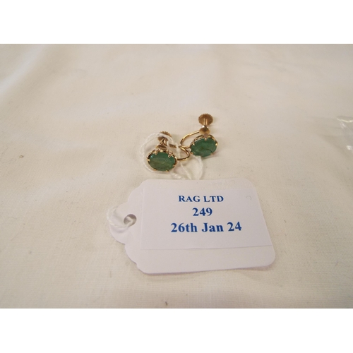 249 - A pair of 9k gold earrings inset with natural oval emeralds