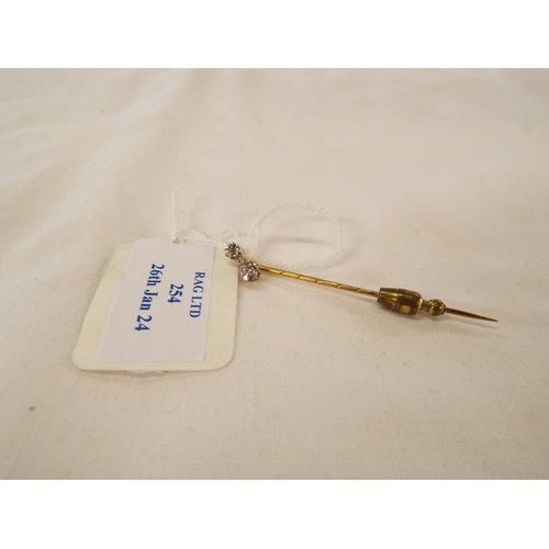 254 - A vintage 9ct gold stick pin inset with three diamonds