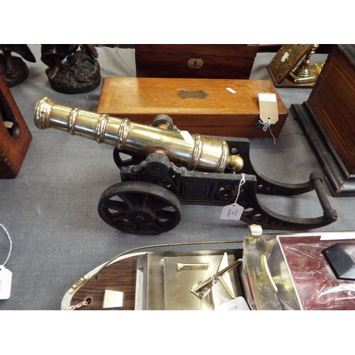 324 - A vintage brass cannon mounted on an iron carriage