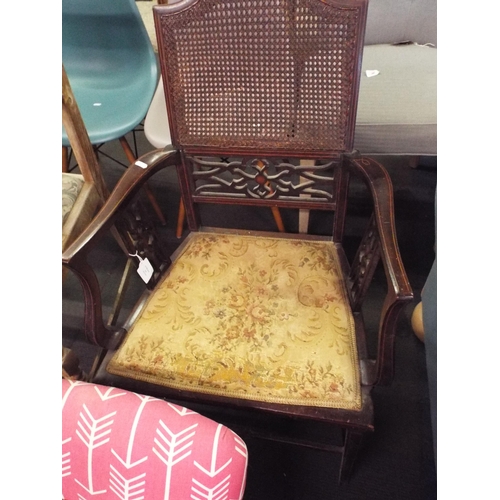 479 - An Edwardian mahogany inlaid elbow chair with bergere back panel, tapestry seat resting on tapering ... 