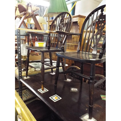 485 - A stained wood dining table, four wheel and stick back and two carver chairs