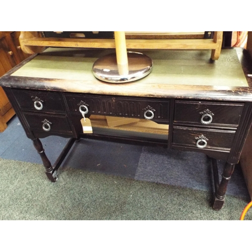 496 - A stained wood desk having green leather inset central long drawer flanked by four short drawers