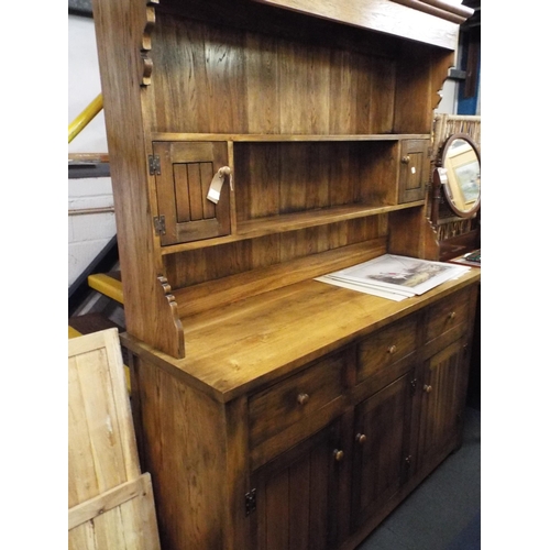 503 - A good quality oak dresser the top having two plate racks and small cupboards above three short draw... 