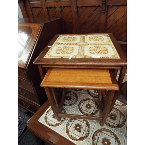 523 - A nest of three mid-century G Plan teak tiled top tables