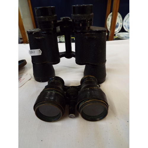 143 - A pair of antique binoculars housed in a case together with a pair of Voyageur 7 x 35 binoculars