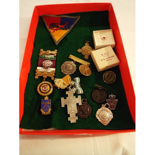 161 - A mixed selection of military items to include an A.R.C pin, badges etc