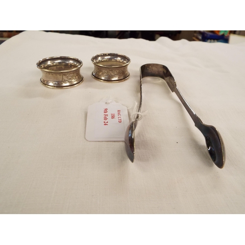 186 - Two silver napkin rings and a pair of sugar tongs