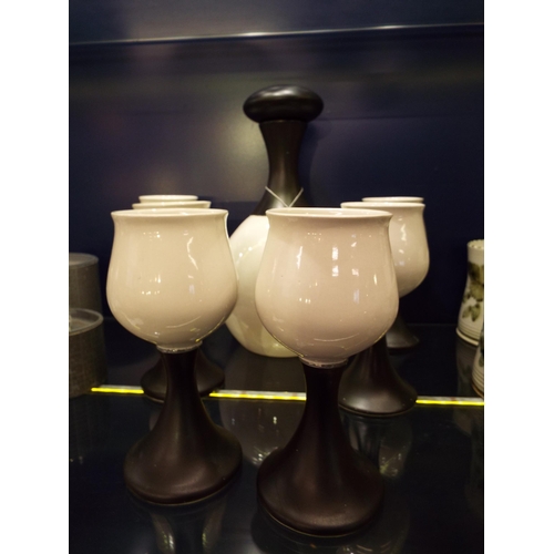 42 - A 1973 Iden Pottery flask and six goblets made for Zarcks decorated in black matt and glossy white g... 