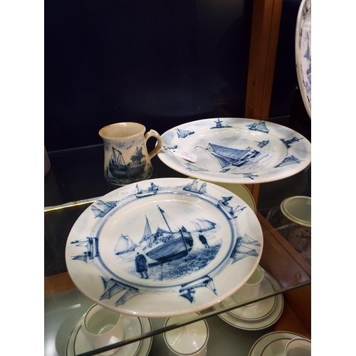 64 - An Iden Pottery plate and tankard with RX Fishing boat decoration together with another Iden pottery... 