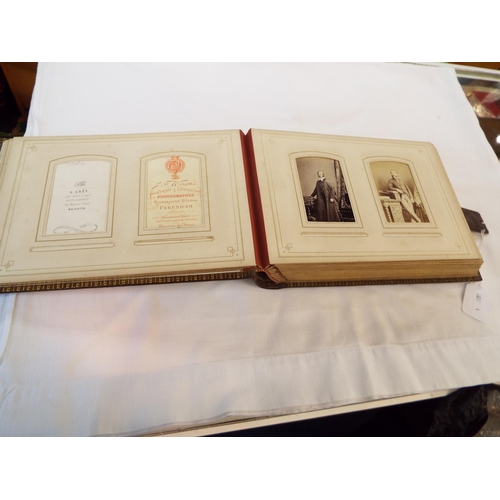 71 - A Victorian leather bound photograph album housing a selection of photographs