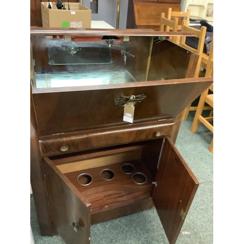 521 - A retro teak Turnidge cocktail cabinet the hinged flap enclosing mirror with drawer and cupboard und... 