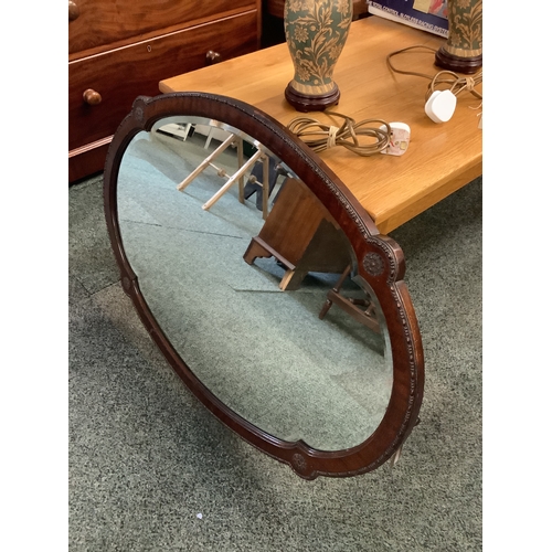 527 - A large oval mahogany framed wall mirror